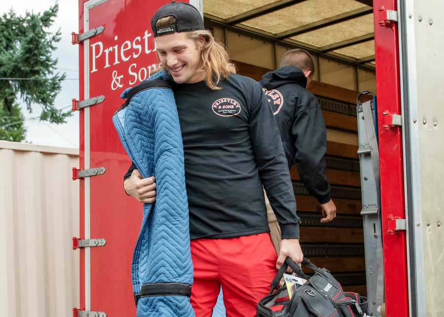 Commercial movers carrying moving supplies
